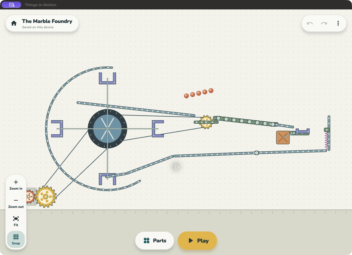 Things In Motion on Mac: a working marble machine with a bucket wheel, gears, ramps and a spring-loaded platform